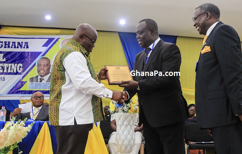 President Akufo-Addo receiving a citation from Rev. Prof. Dr. Paul Frimpong Manso, the General Superintendent of "Assemblies of God" Churches Ghana.